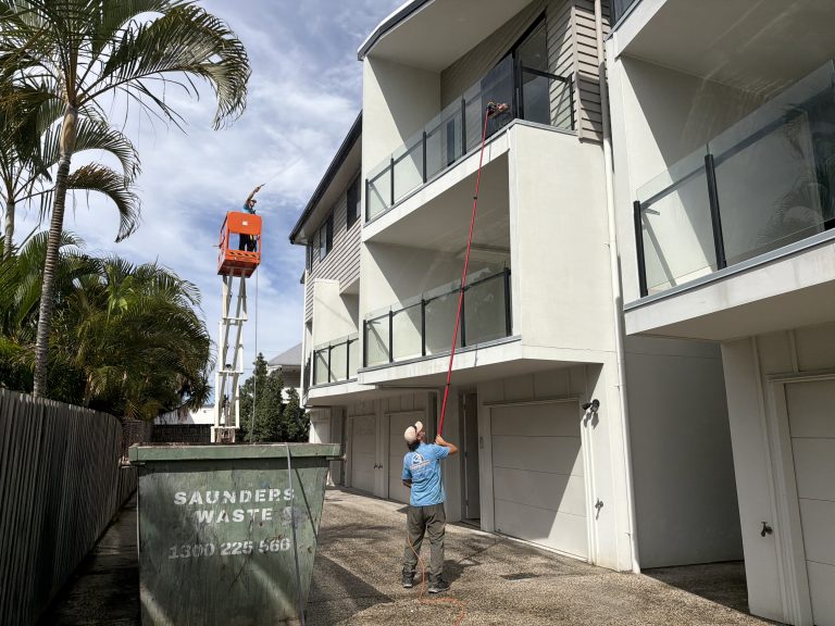 Jetstream technician washing a townhouse block from an elevated work platform